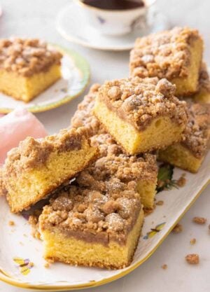 A platter of square pieces of crumb cake.