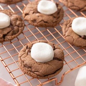 A cooling rack with hot chocolate cookies on it.