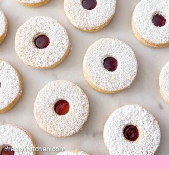 Pinterest graphic of a single layer of multiple linzer cookies.