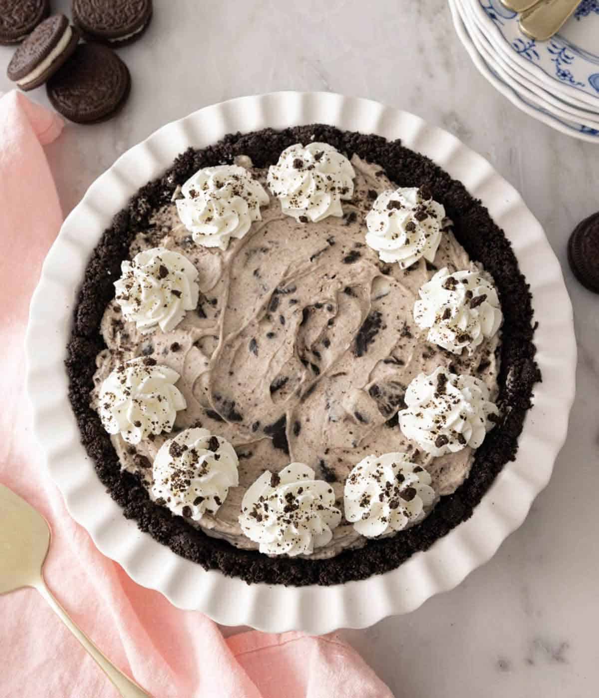 Overhead view of a Oreo pie with whipped cream piped around the edge.