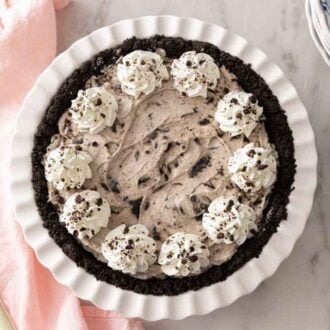 An Oreo pie with dollops of whipped cream piped on top.