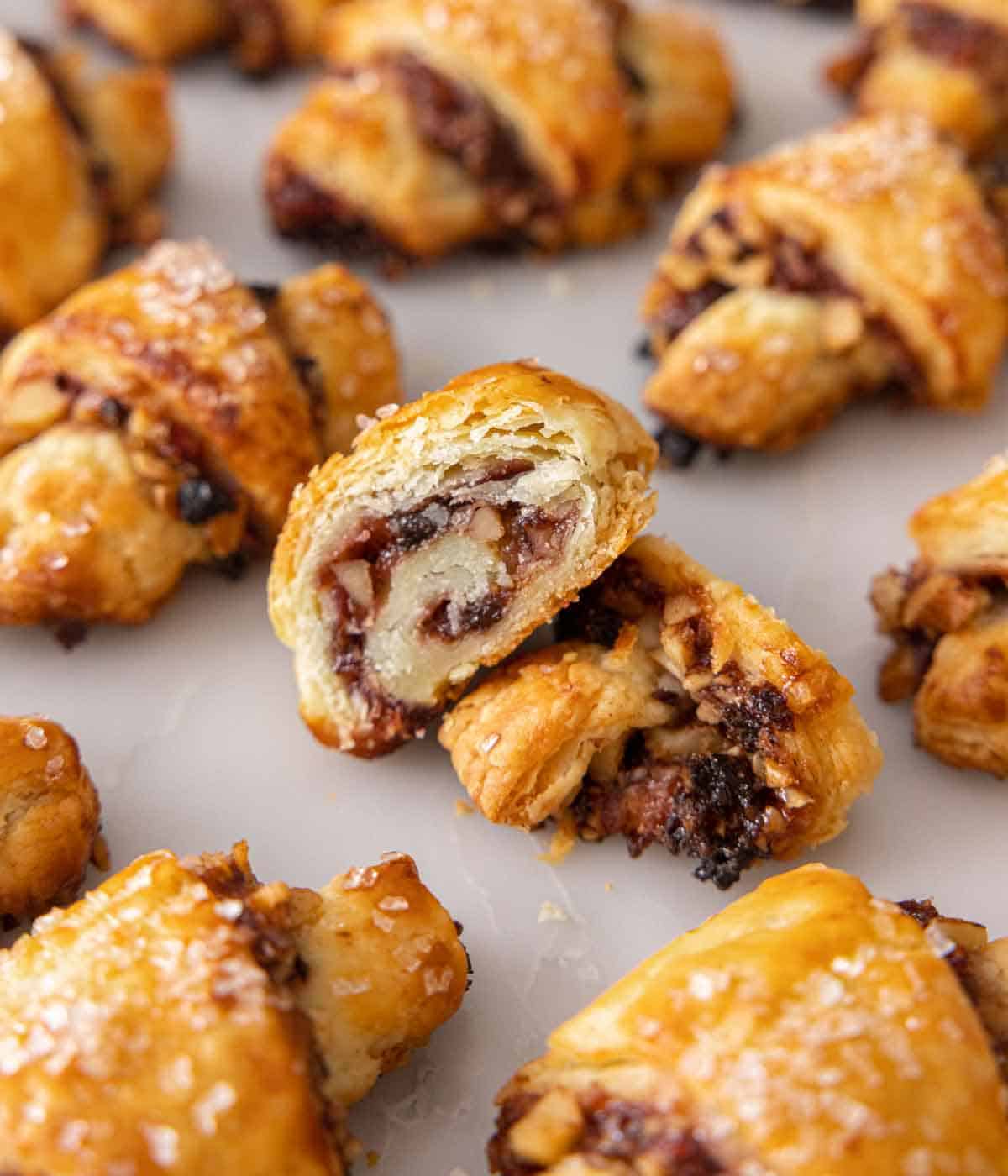 Multiple rugelach with one cut in half, showing the cross section.