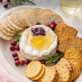 Pinterest graphic of a platter of baked brie with crackers around it.