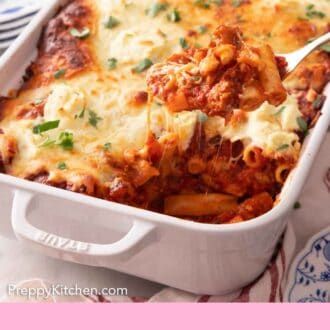 Pinterest graphic of a baking dish of baked ziti with a spoonful lifted out.