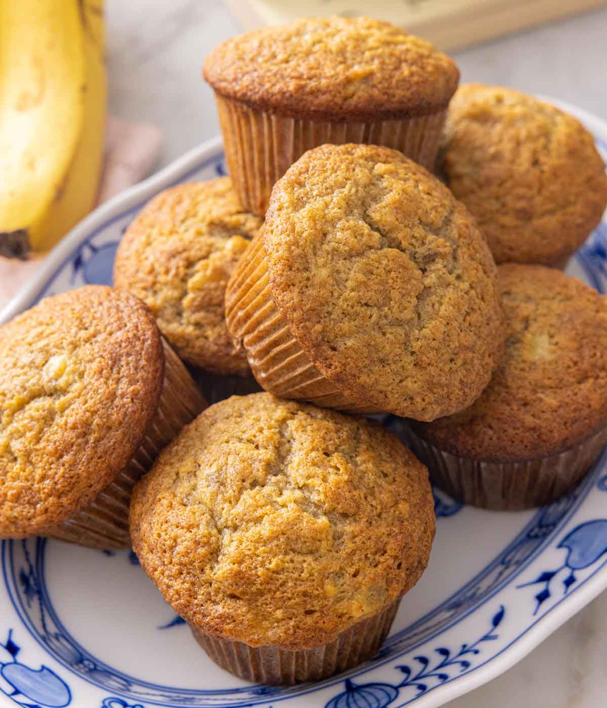 A platter with a pile of banana muffins.