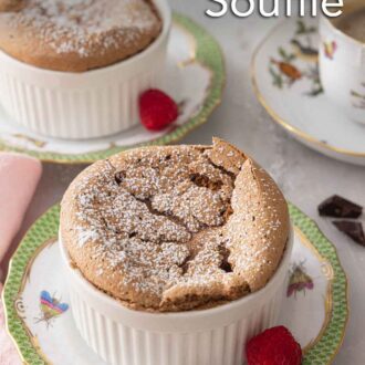 Pinterest graphic of a chocolate souffle with powdered sugar on top with a raspberry on the side.