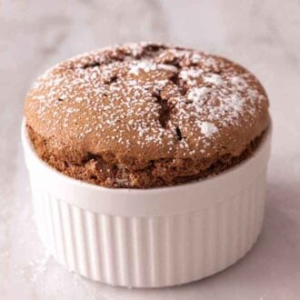 A chocolate souffle with powdered sugar dusted on top.