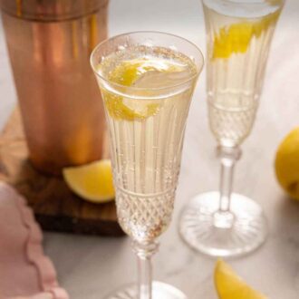Pinterest graphic of two glasses of French 75 cocktails.