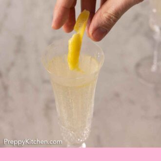 Pinterest graphic of a lemon peel garnish added to a glass of French 75.
