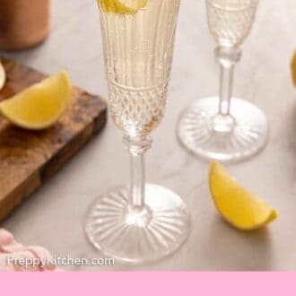 Pinterest graphic of a glass of French 75 cocktail with lemon twist garnish.