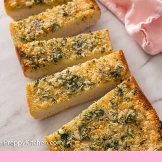 Pinterest graphic of a loaf of garlic bread, cut into slices.