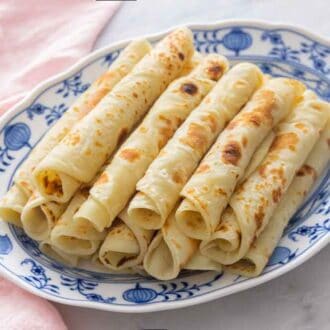 A platter of lefse, rolled and stacked.