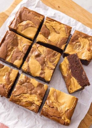 A cutting board of peanut butter brownies cut into 9 servings.