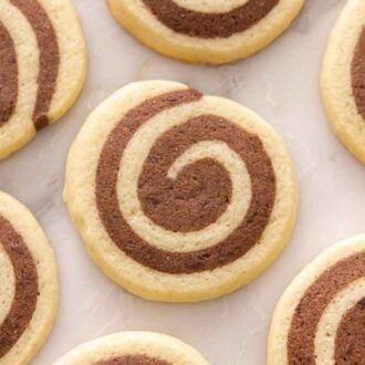 A single layer of pinwheel cookies on a marble surface.