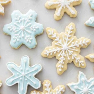 Overhead view of snowflake cookies decorated with icing.
