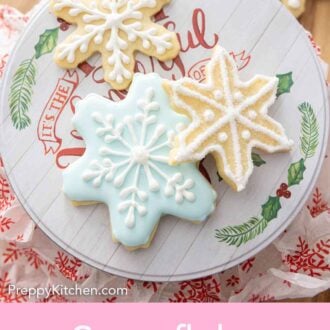 Pinterest graphic of three snowflake cookies decorated with white and blue icing.