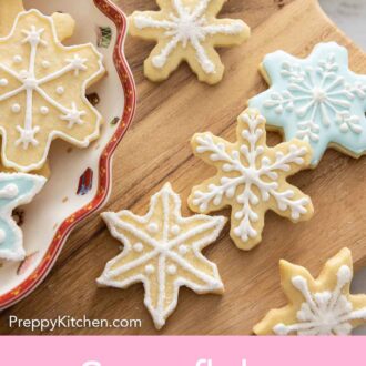 Pinterest graphic of a wooden serving board with snowflake cookies.