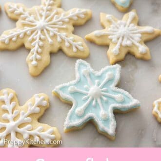 Pinterest graphic of multiple decorated snowflake cookies.