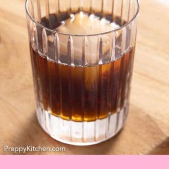 Pinterest graphic of a Black Russian on a wooden serving board.