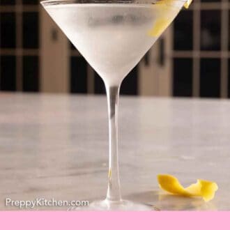 Pinterest graphic of a glass of martini with lemon garnish in the drink and beside it.