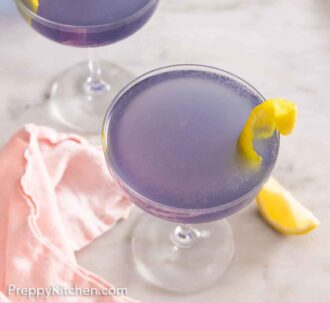 Pinterest graphic of an overhead view of two Aviation cocktails with lemon twist garnishes.