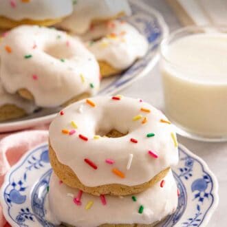 Pinterest graphic of a stack of two glazed baked donuts with sprinkles on top.