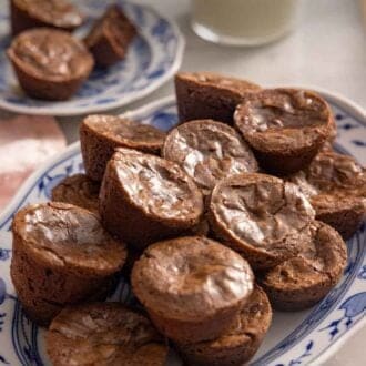 Pinterest graphic of a platter of brownie bites with milk in the background.