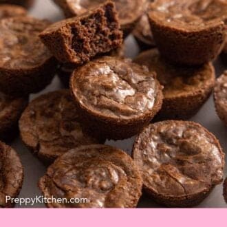 Pinterest graphic of multiple brownie bites with one on top with a bite taken out.