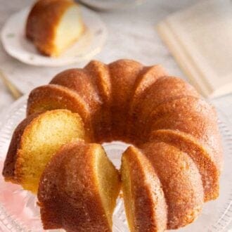 Pinterest graphic of a butter cake on a cake stand with a slice cut.