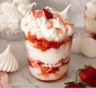 Pinterest graphic of a glass of Eton mess with meringues scattered around.