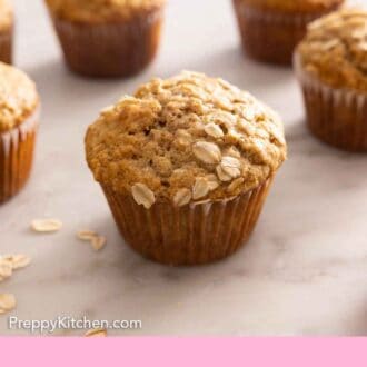 Pinterest graphic of oatmeal muffins cooling on a counter.
