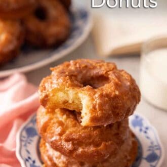 Pinterest graphic of a stack of three old fashioned donuts with the top missing a bite.