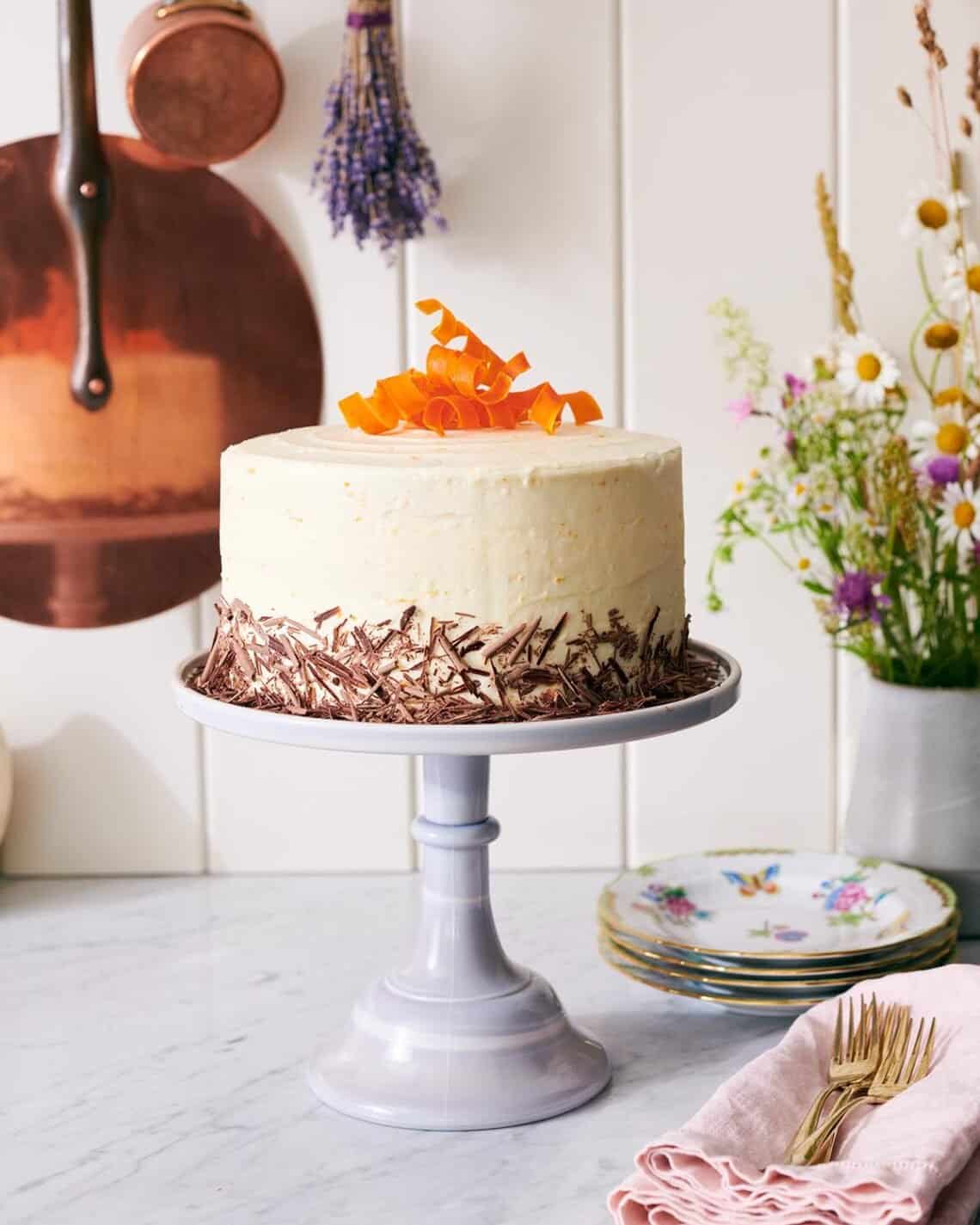 A chocolate carrot cake topped with candied carrot curls.