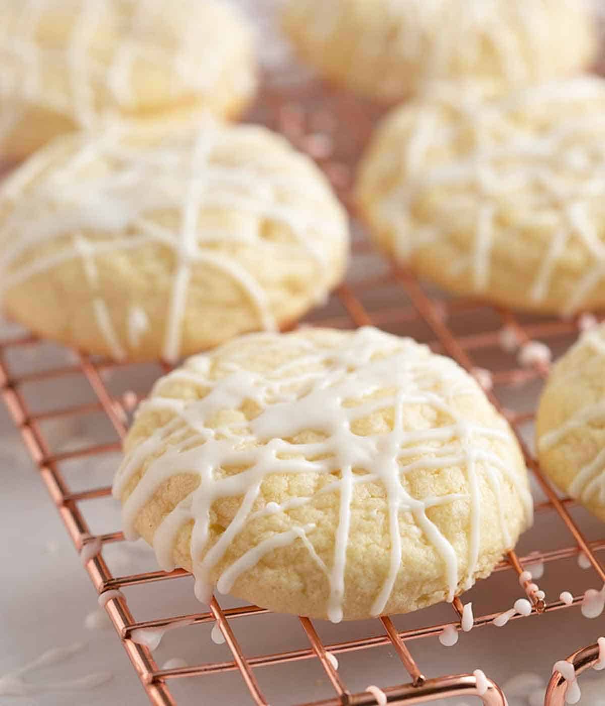 A wire rack with glazed lemon cookies.
