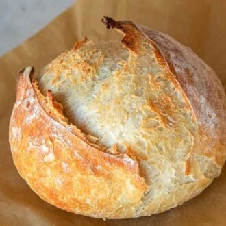 Artisan bread on a piece of parchment paper.