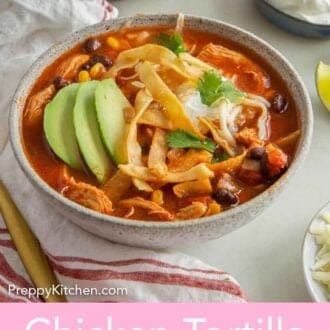 Pinterest graphic of a bowl of chicken tortilla soup with sliced avocado, sour cream, and cilantro.