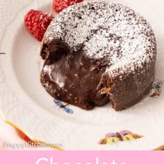 Pinterest graphic of a chocolate lava cake with powdered sugar on top, with the middle oozing out.