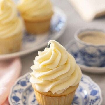 A cupcake with cream cheese frosting on top.