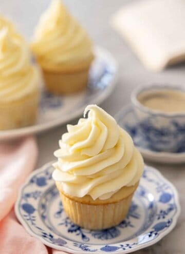 A cupcake with cream cheese frosting on top.