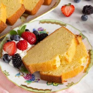 A plate with two slices of pound cake with berries.