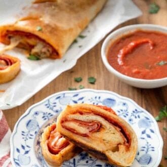 Pinterest graphic of a plate with two pieces of stromboli by pizza sauce and uncut stromboli.