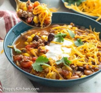 Pinterest graphic of a spoonful of taco soup lifted from the bowl.