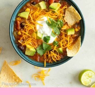 Pinterest graphic of a bowl of taco soup with toppings in the soup and scattered around.