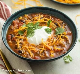 Pinterest graphic of a bowl of taco soup with sour cream, shredded cheese, and cilantro on top.
