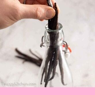 Pinterest graphic of a bunch of vanilla beans added into a bottle.