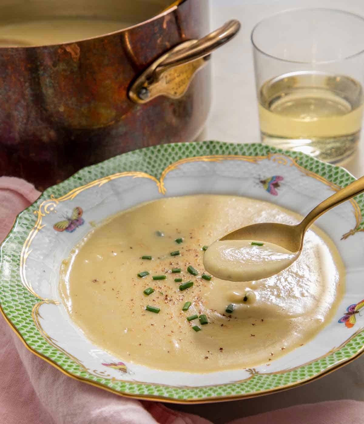 A bowl of vichyssoise with a spoonful lifted out.
