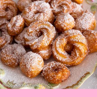 Pinterest graphic of a plate of zeppole with powdered sugar dusted on top.