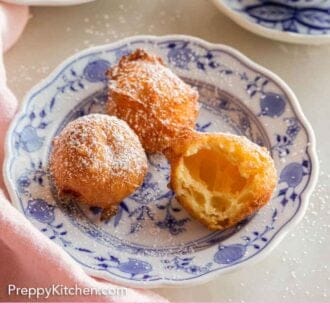 Pinterest graphic of three zeppole on a plate, one cut opened.