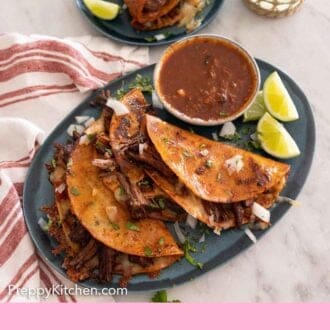 Pinterest graphic of a platter of three birria tacos with dip and lime wedges.
