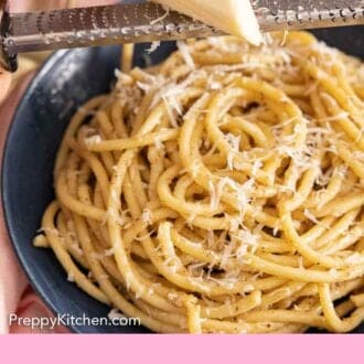 Pinterest graphic of cheese grated over a bowl of cacio e pepe.